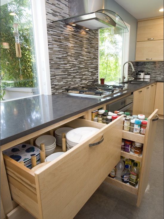 an open cabinet in the middle of a kitchen