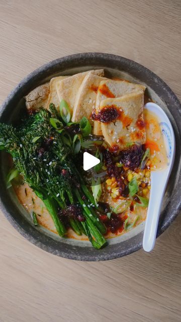 a bowl filled with food on top of a wooden table