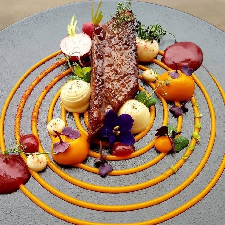 a plate topped with meat and vegetables on top of a table