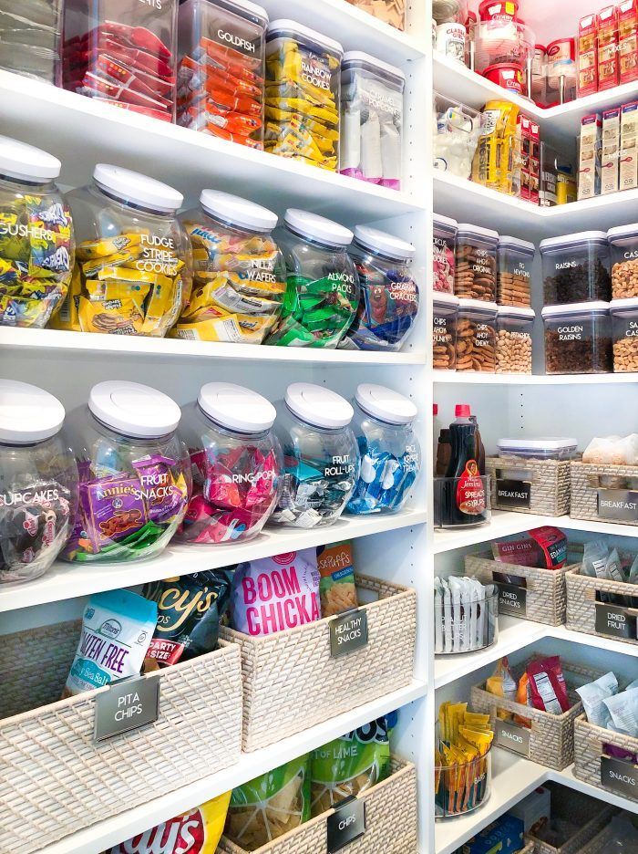 a pantry filled with lots of food and containers full of condiments on shelves