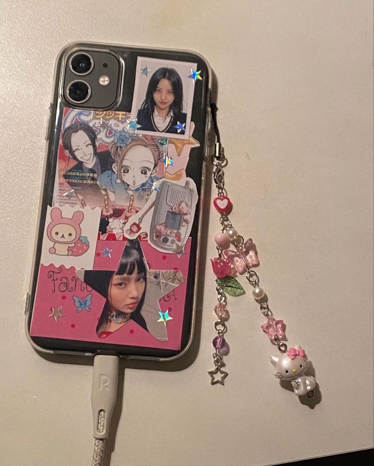 a cell phone case with some pictures on it and a keychain attached to it