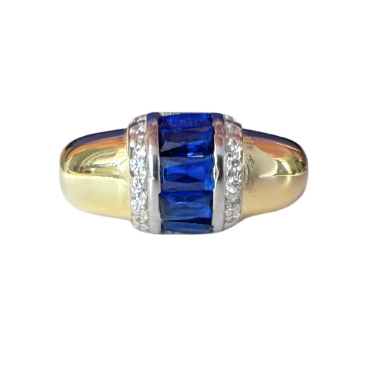 Introducing our Sapphire Crystal Gold Plated Silver Ring, a true embodiment of elegance and beauty. This exquisite ring features a stunning sapphire crystal set in luxurious gold-plated silver. The timeless design showcases the deep, captivating blue of the sapphire, making it a standout piece in any jewelry collection. Perfect for adding a touch of sophistication to any outfit, this ring is ideal for special occasions or everyday wear. Elevate your style with the refined elegance of our Sapphire Crystal Gold Plated Silver Ring. To ensure your Sapphire Crystal Gold Plated Silver Ring remains beautiful, follow these care instructions:  1. Avoid Harsh Chemicals: Keep your ring away from perfumes, lotions, and household cleaners to prevent damage to the gold plating and sapphire crystal. 2. R Channel Set Sapphire Rings With Emerald Cut, Channel Set Emerald Cut Sapphire Rings, Elegant Blue Diamond Birthstone Ring, Elegant Blue Birthstone Ring For Anniversary, Formal Sapphire Cubic Zirconia Ring, Elegant Gold Ring With Blue Topaz, Formal Blue Cubic Zirconia Birthstone Ring, Elegant Birthstone Ring Channel Set Gift, Gold Sapphire Ring With Accent Stones For Formal Occasions