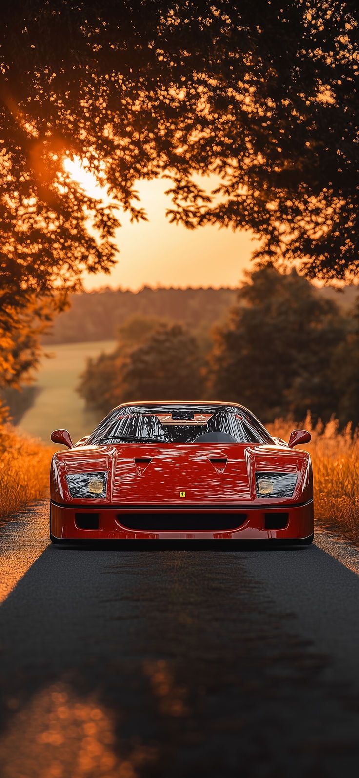 a red sports car parked on the side of a country road at sunset or dawn