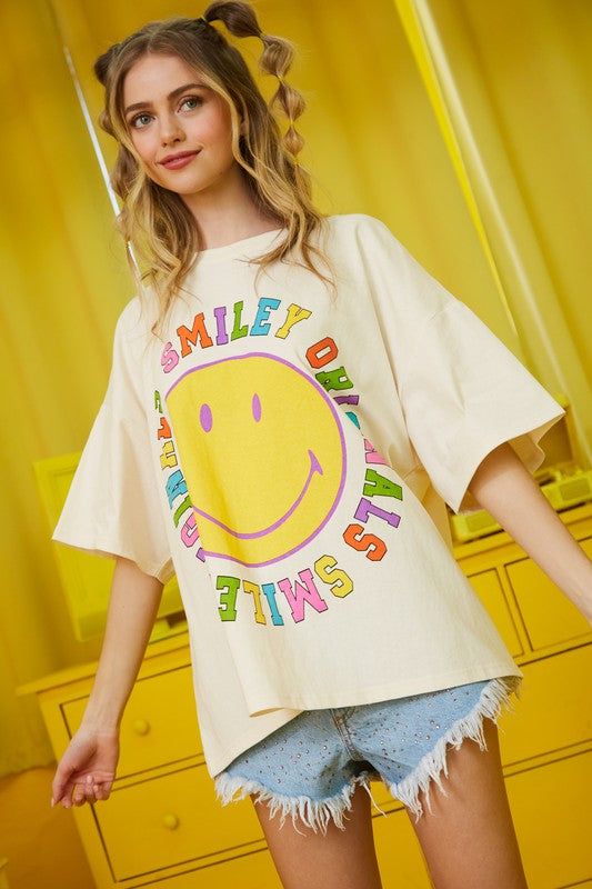 Introducing the Smiley Originals Graphic Tee - the perfect addition to any wardrobe. Made with high-quality materials and featuring a bold and eye-catching design, this tee is sure to make a statement. Express yourself with this unique and stylish piece. Trendy Multicolor T-shirt With Text Print, Pop Culture Graphic Crew Neck Tops, Trendy Crew Neck T-shirt With Front Print, Spring Multicolor Graphic T-shirt, Oversized Retro T-shirt For Spring, Retro Slogan T-shirt For Spring, Oversized Multicolor Graphic Print T-shirt, Pop Culture Graphic Design Tops For Summer, Cotton Pop Culture Tops For Summer