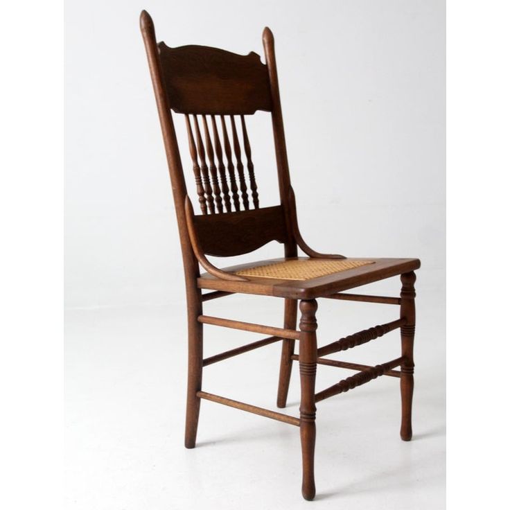 an old wooden chair with wicker seat and backrests on a white background