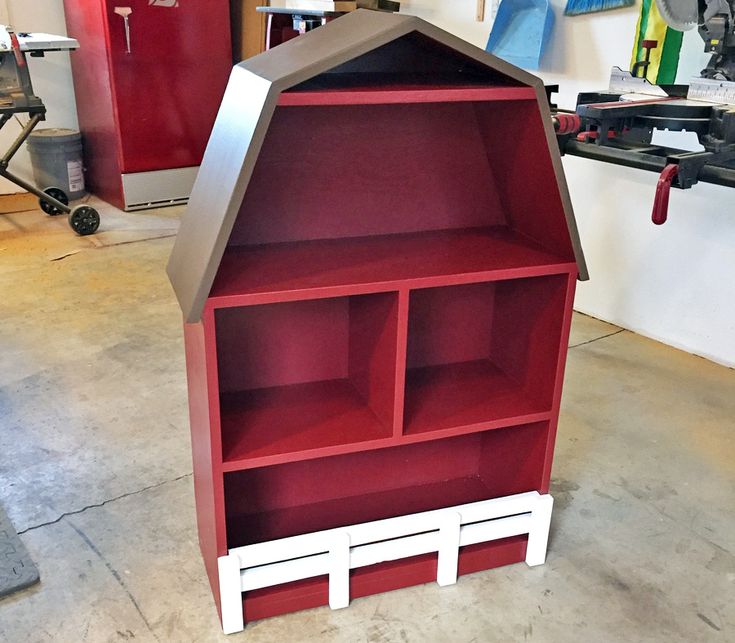 a red and white shelving unit in a garage