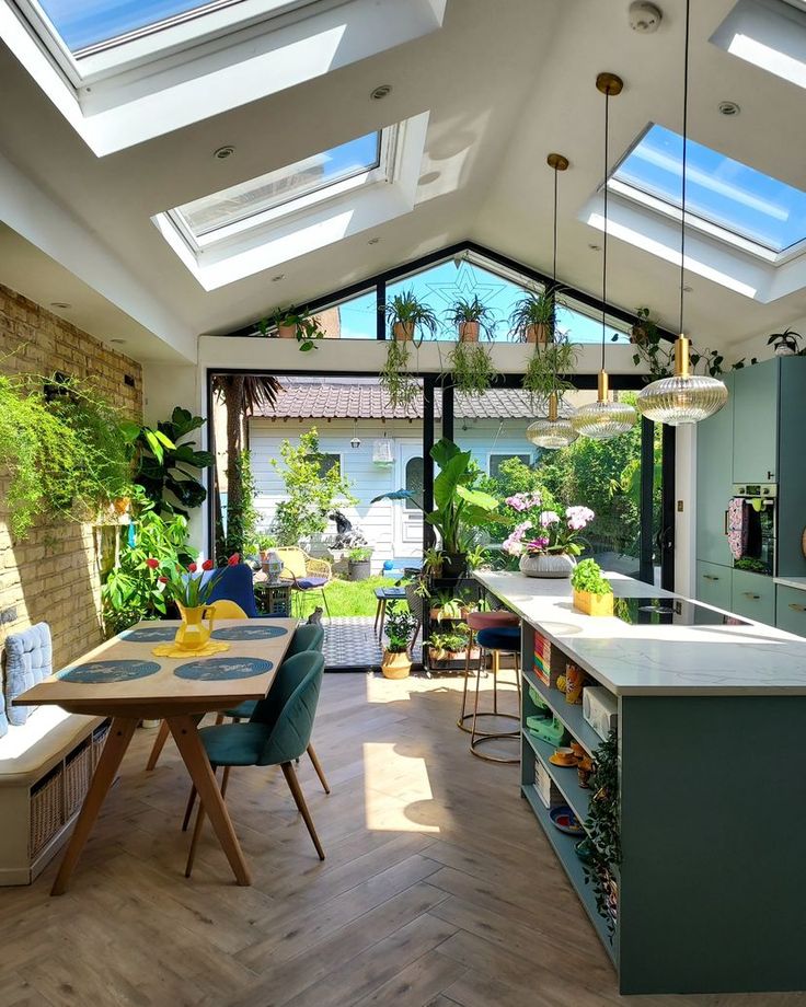 an open kitchen and dining room with skylights