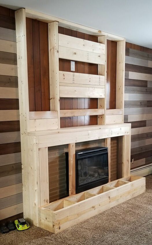 a living room with wood paneling and a fire place in the middle of it