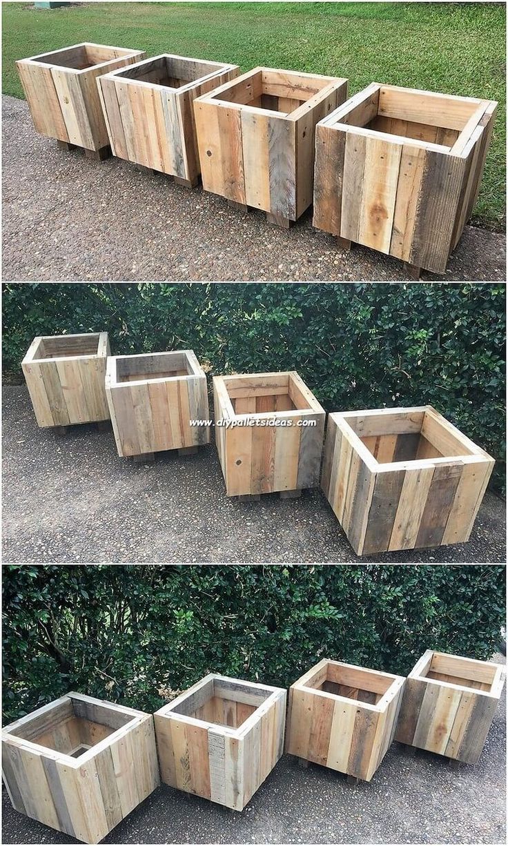 several wooden planters sitting on top of each other in front of some grass and bushes