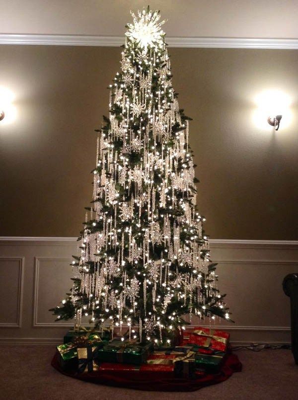 a white christmas tree with lights and presents on the bottom is shown in an instagram post