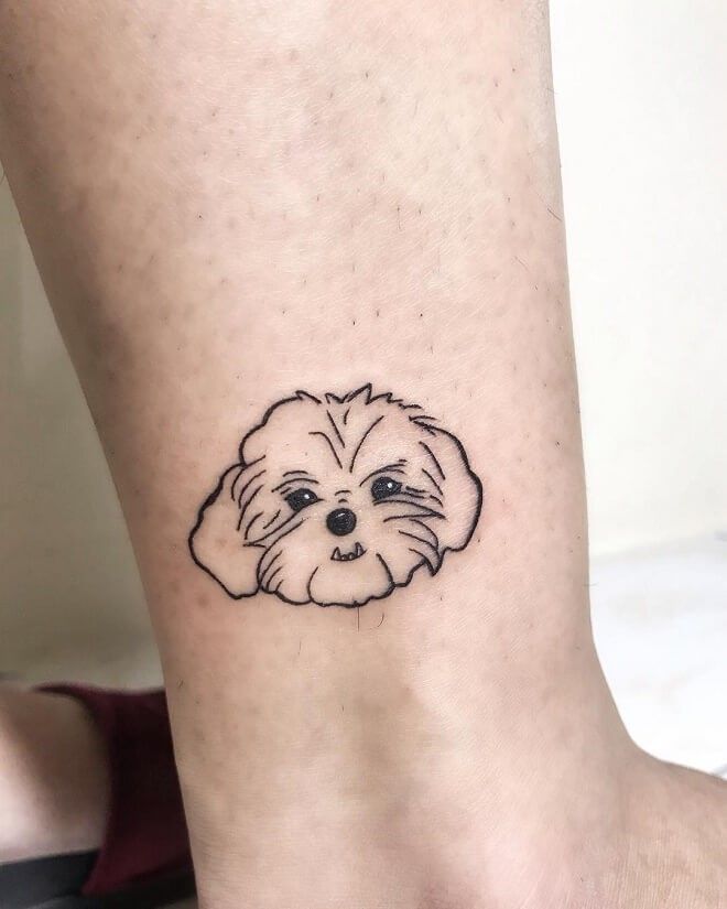 a small dog tattoo on the ankle