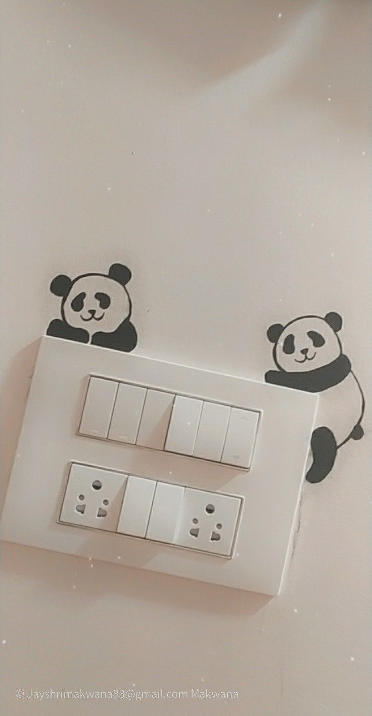 an electrical outlet with two pandas on it