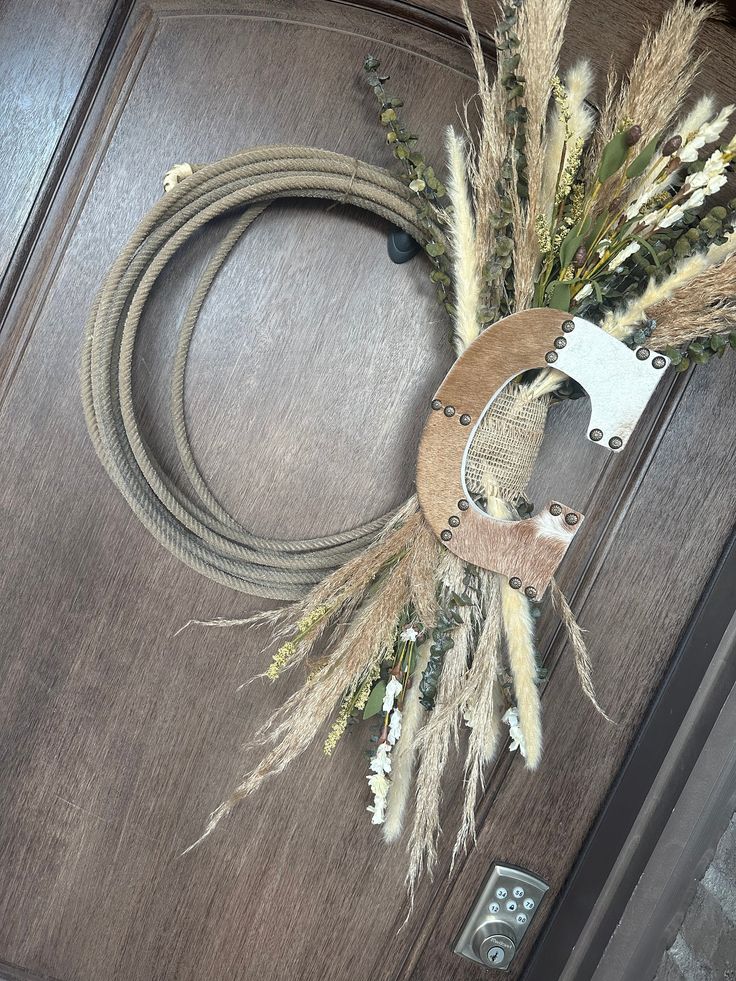 a door with a rope and some flowers on it