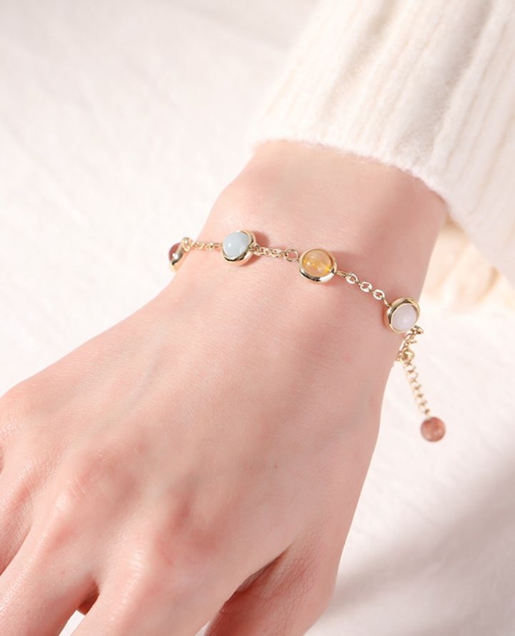 This exquisite multicolor stone bracelet is crafted from a combination of the finest materials and with the utmost care. The vibrant colors give it a luxurious and sophisticated feel, ensuring it will be a striking addition to any outfit. Perfect for adding a touch of glamour to special occasions. Trendy Gold Plated Round Bracelet, Multicolor Gold Bracelet Gift, Elegant Natural Stones Crystal Bracelet Gift, Elegant Crystal Bracelet With Natural Stones For Gift, Multicolor Adjustable Chain Bracelet, Multicolor Gold Bangle Bracelet As A Gift, Multicolor Bangle Gold Bracelet As A Gift, Elegant Crystal Gemstone Bracelet, Multicolor Gold Jubilee Bracelet