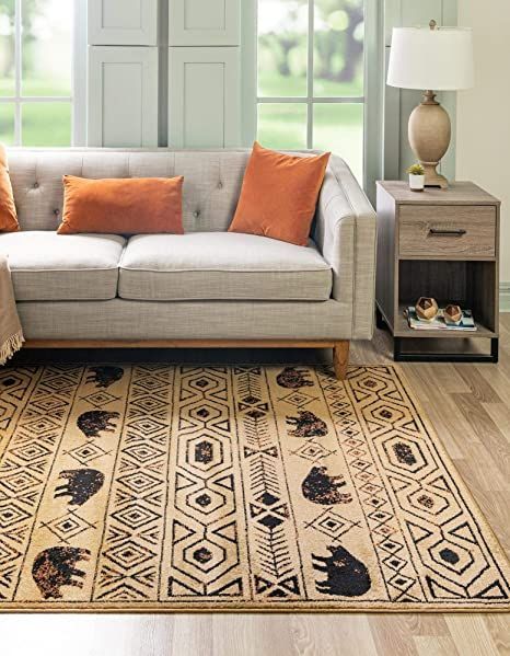 a living room scene with focus on the couch and rug in front of the window