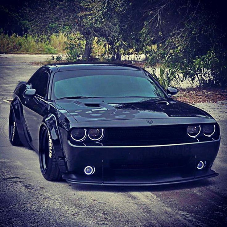 a black car parked on the side of a road