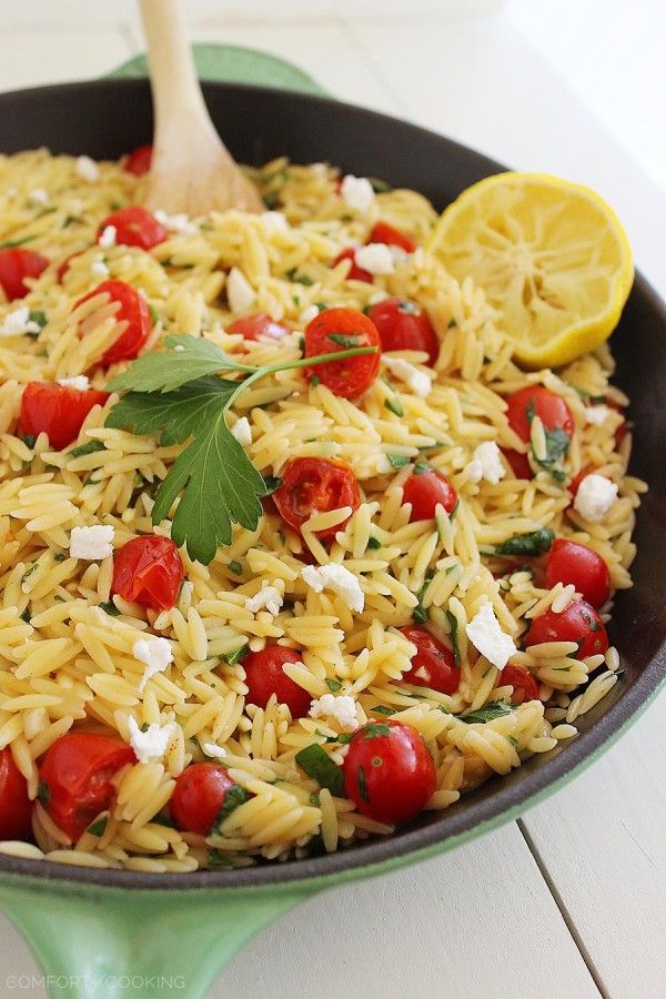 a skillet filled with pasta and cherry tomatoes