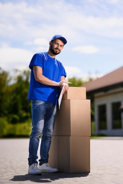 a man standing next to a cardboard box