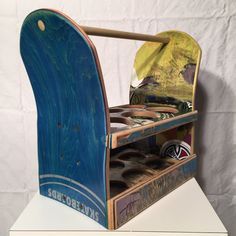 an old wooden toy sled with shoes in it's storage compartment on top of a white table