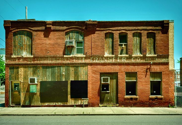 an old brick building with boarded up windows