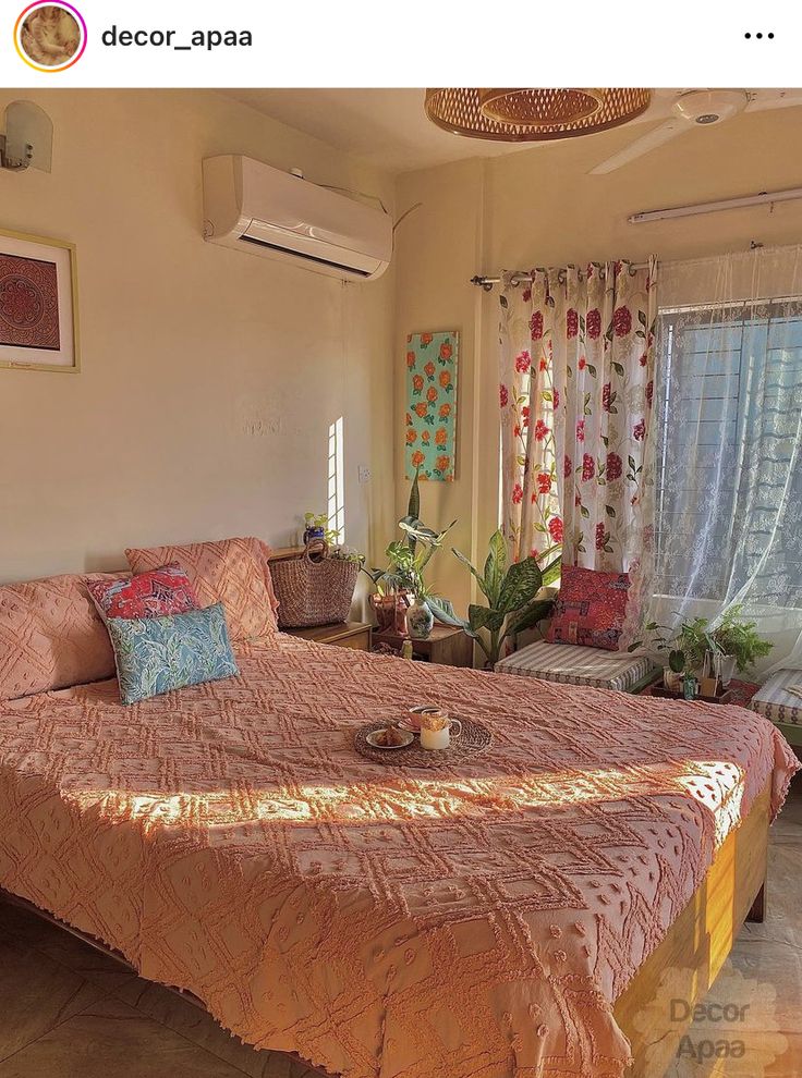 a bed room with a neatly made bed next to a window and a ceiling fan