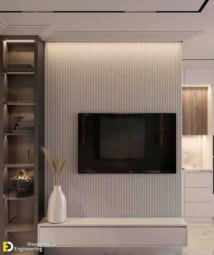 the television is mounted on the wall in the living room, and it's surrounded by shelving