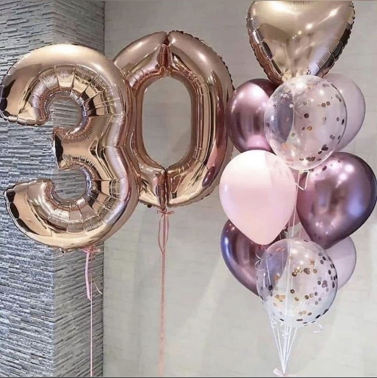 some balloons that are in the shape of the number 30