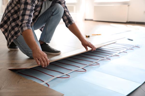 a man kneeling down on top of a wooden floor