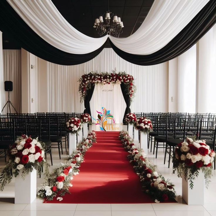 the aisle is decorated with red and white flowers