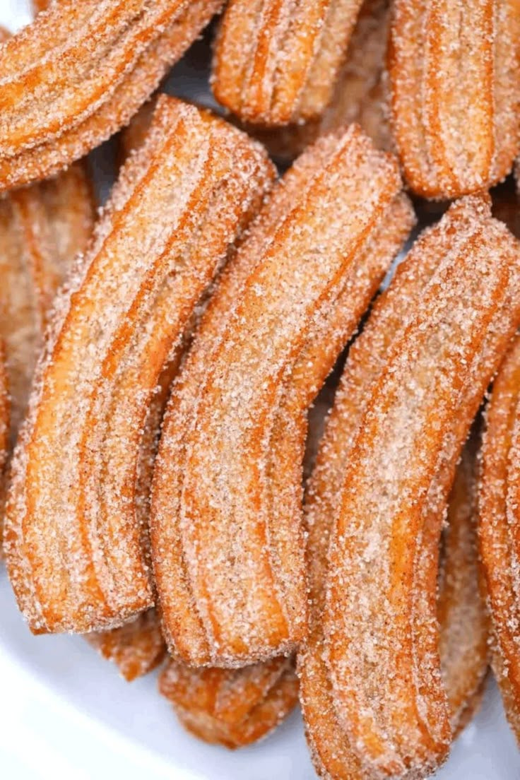 some sugar covered donuts on a white plate