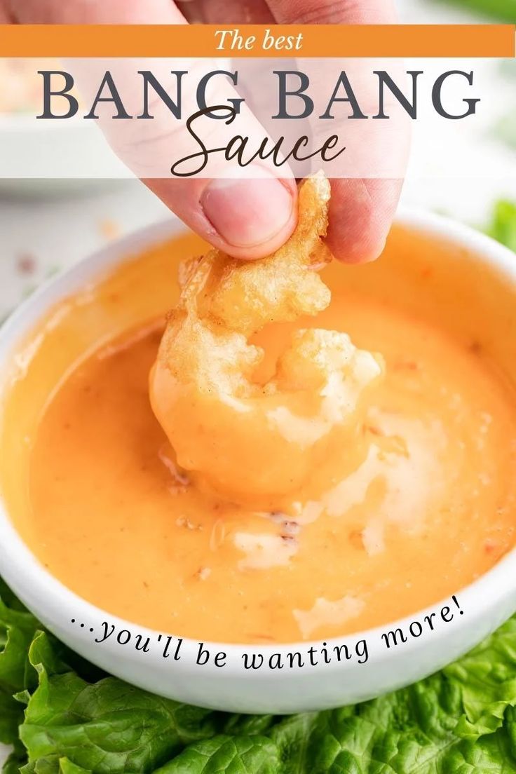 a person dipping some food into a bowl