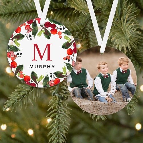 two young boys sitting on a tree ornament with the letter m in it