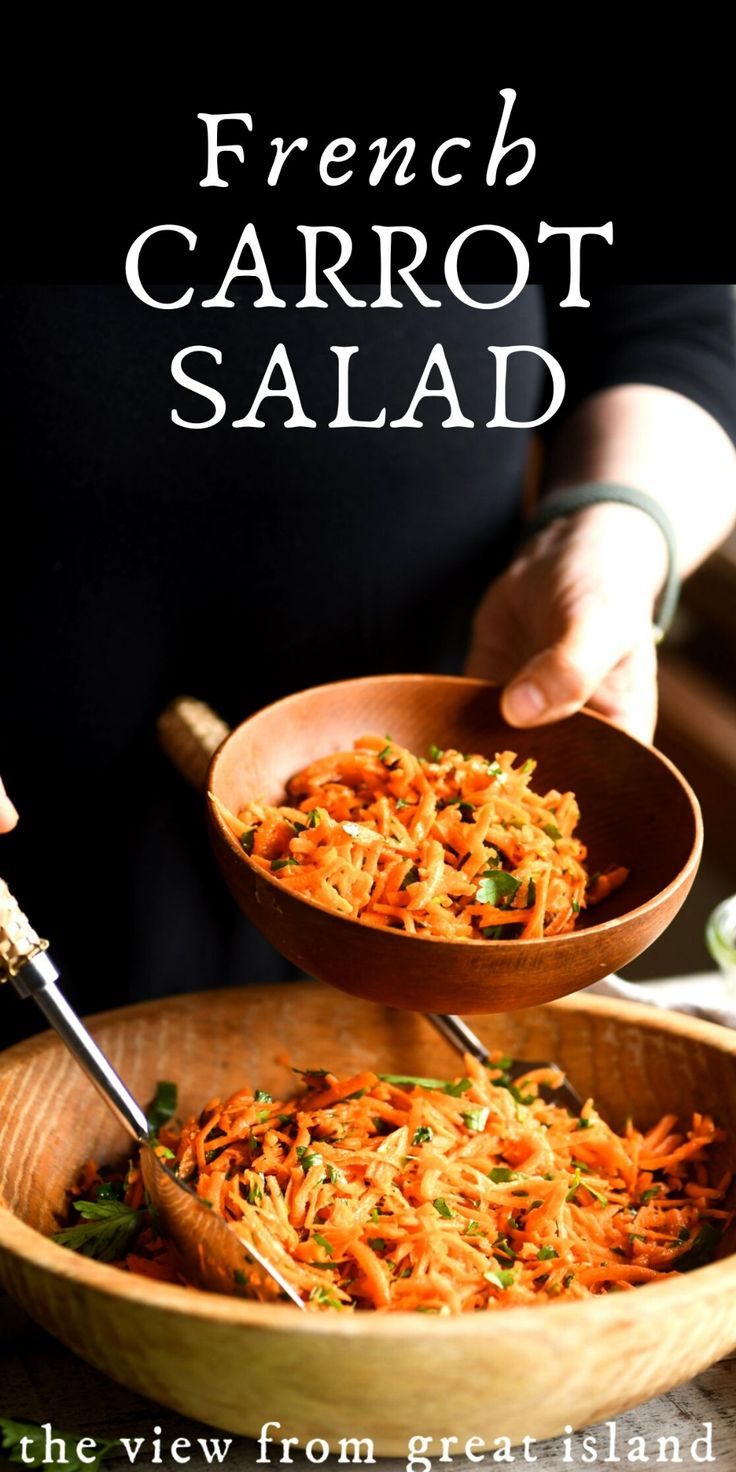 two wooden bowls filled with carrot salad on top of a table