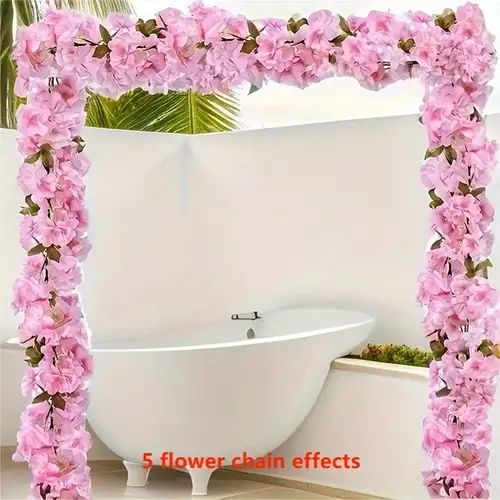 a white bath tub sitting next to a flower covered wall in front of a mirror