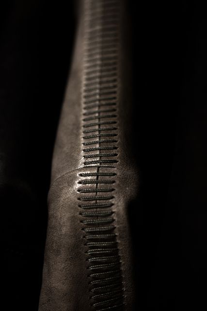 a black and white photo of the back end of someone's foot with an intricate pattern on it