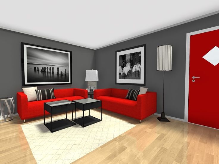 a living room with red couches and pictures on the wall