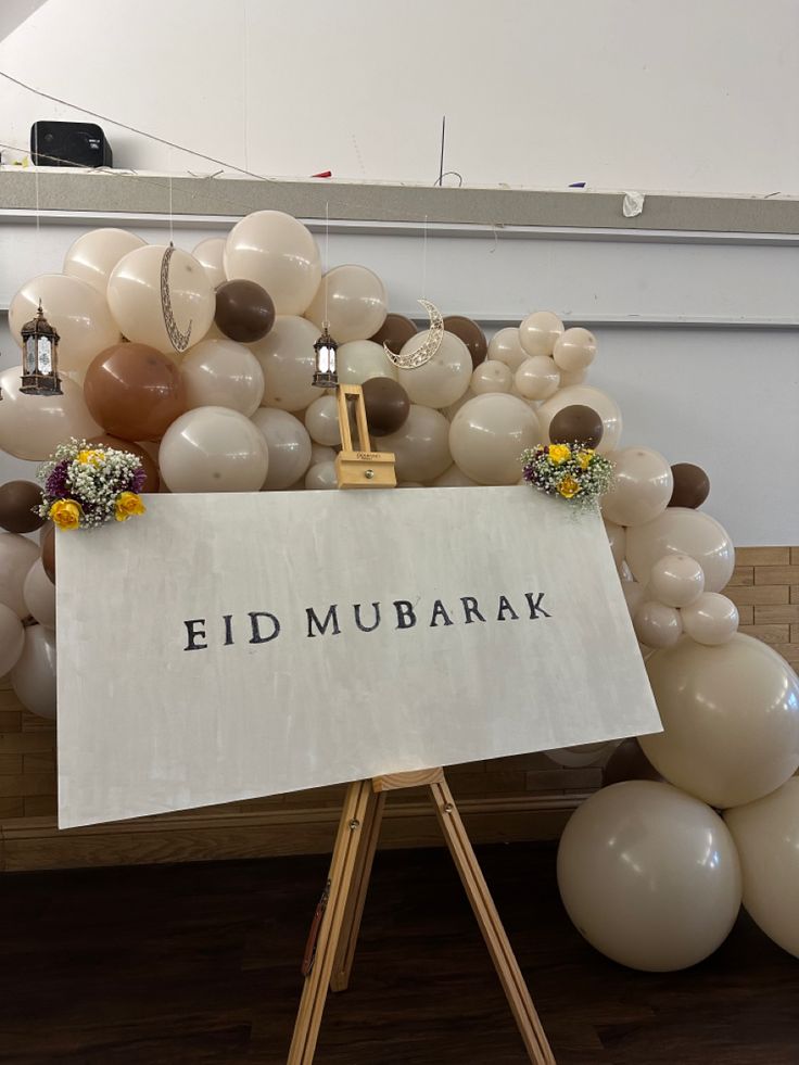 there is a sign that says ed mubarak on it and balloons surrounding it