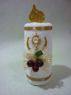 a white and gold decorated canister with grapes on it's side, sitting on a table