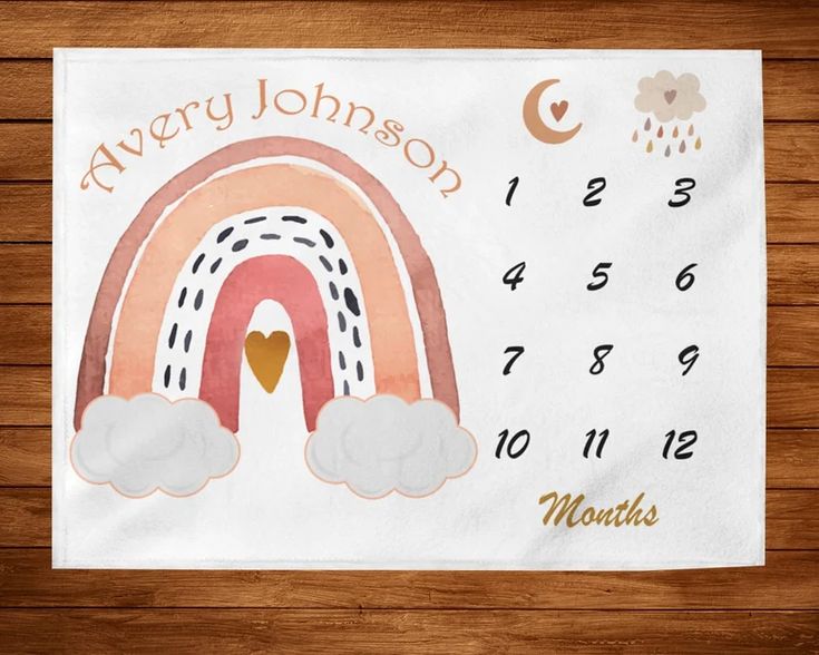 a calendar with a rainbow and clouds on the front, which reads avery johnson