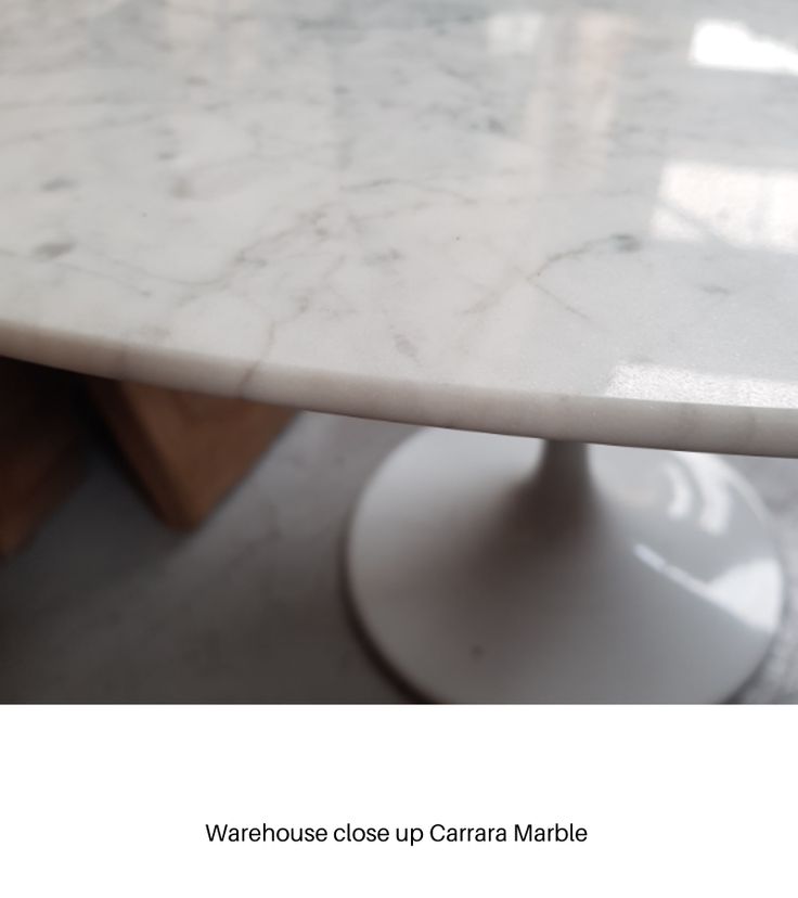 a marble table top sitting on top of a white pedestal