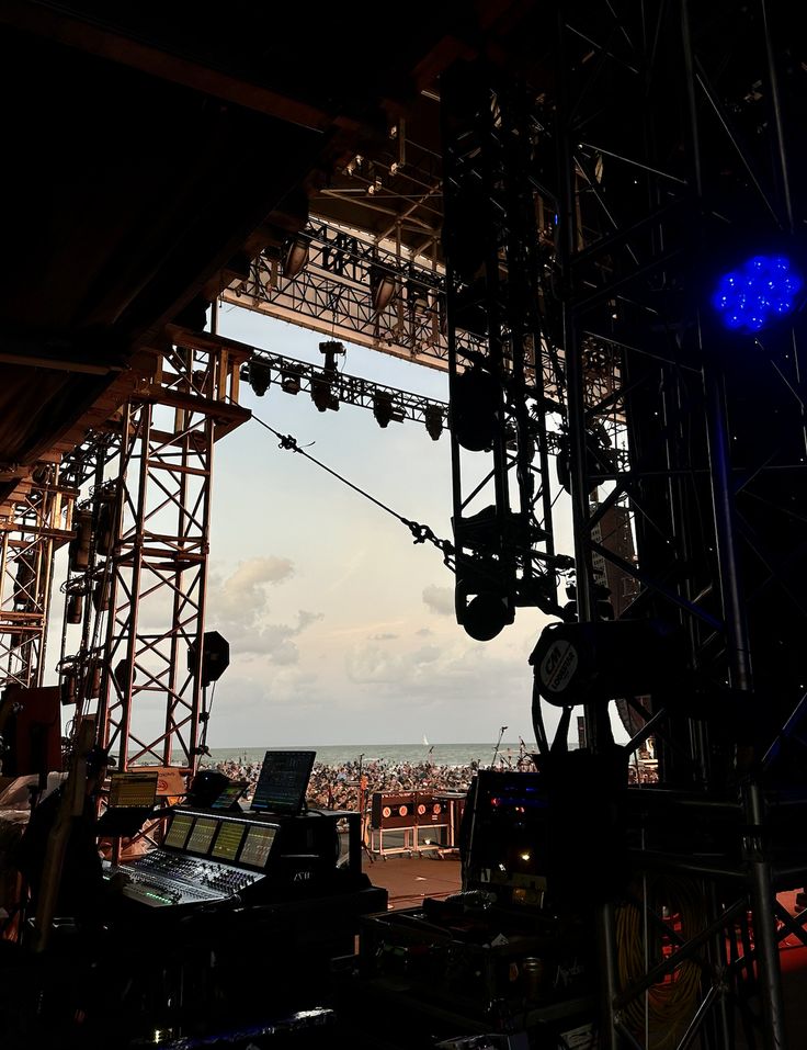 the stage is set up for a concert with blue lights and sound equipment on it