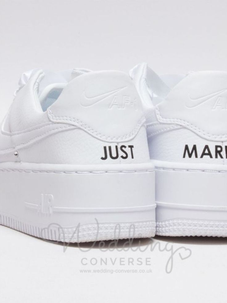 a pair of white shoes with just married written on the upper part of each shoe