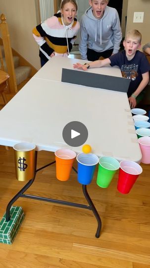 a group of people standing around a table with cups on it