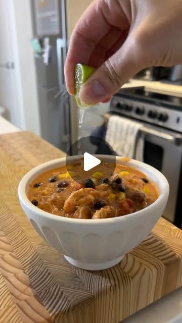 a person is spooning some food into a bowl