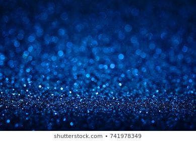 blue glitter background with lots of small sparkles on the bottom, and some blurry lights