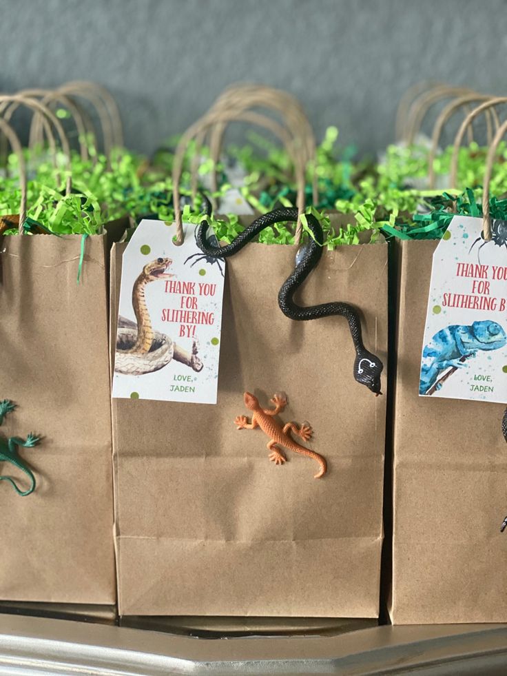 several small bags filled with different types of animals on top of a table next to each other