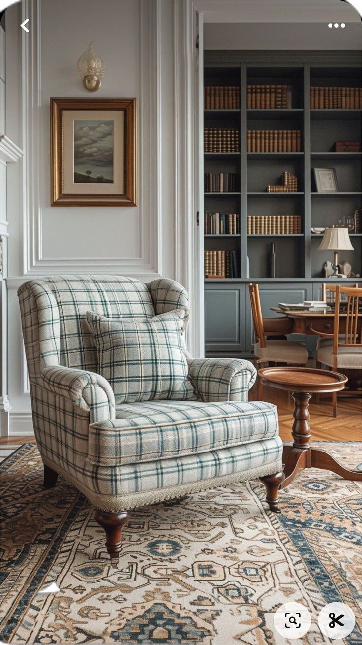 a chair sitting on top of a rug next to a book shelf filled with books