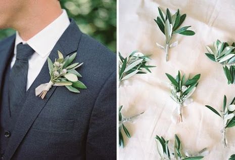 a man in a suit and tie with flowers on his lapel flower pinhole