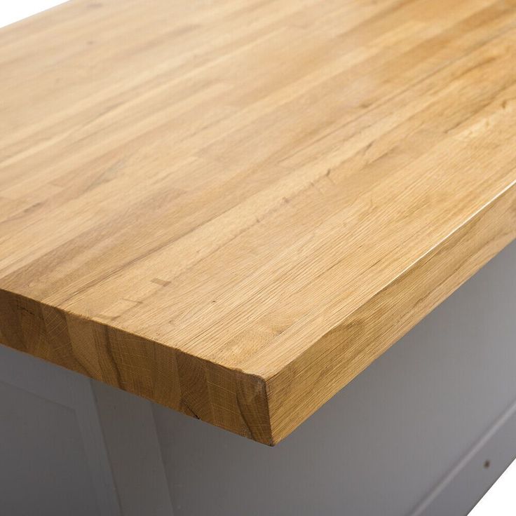 a wooden counter top sitting next to a white wall