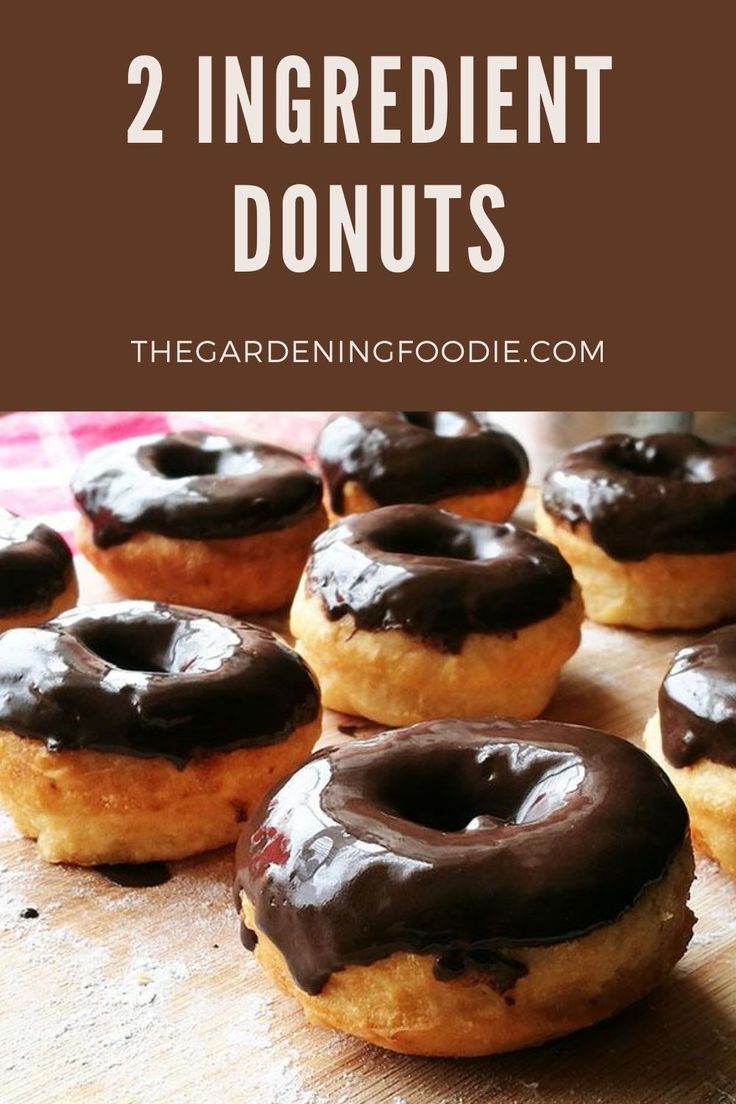 donuts with chocolate frosting and sprinkles on them are sitting on a cutting board